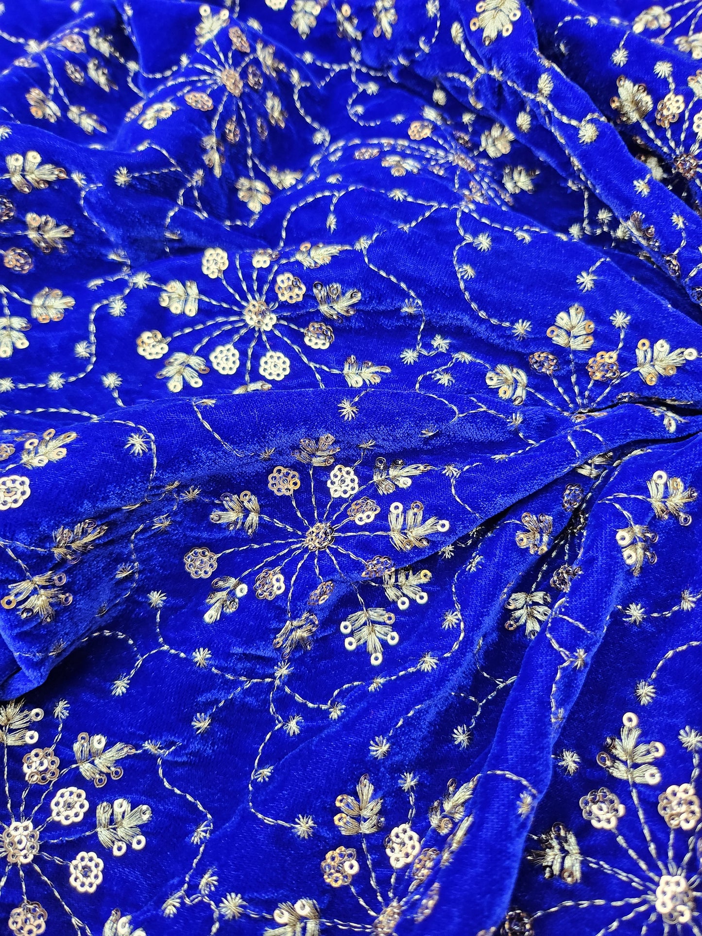 Pure velvet 9000 fabric and comes with beautiful floral trail embroidery blue color with hand woven sequence work