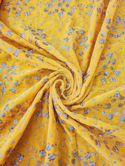 Pure velvet 9000 fabric and comes with beautiful floral trail embroidery yellow color with hand woven sequence work