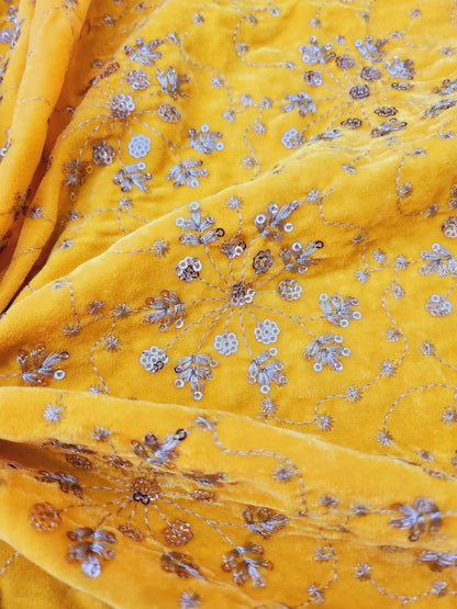 Pure velvet 9000 fabric and comes with beautiful floral trail embroidery yellow color with hand woven sequence work